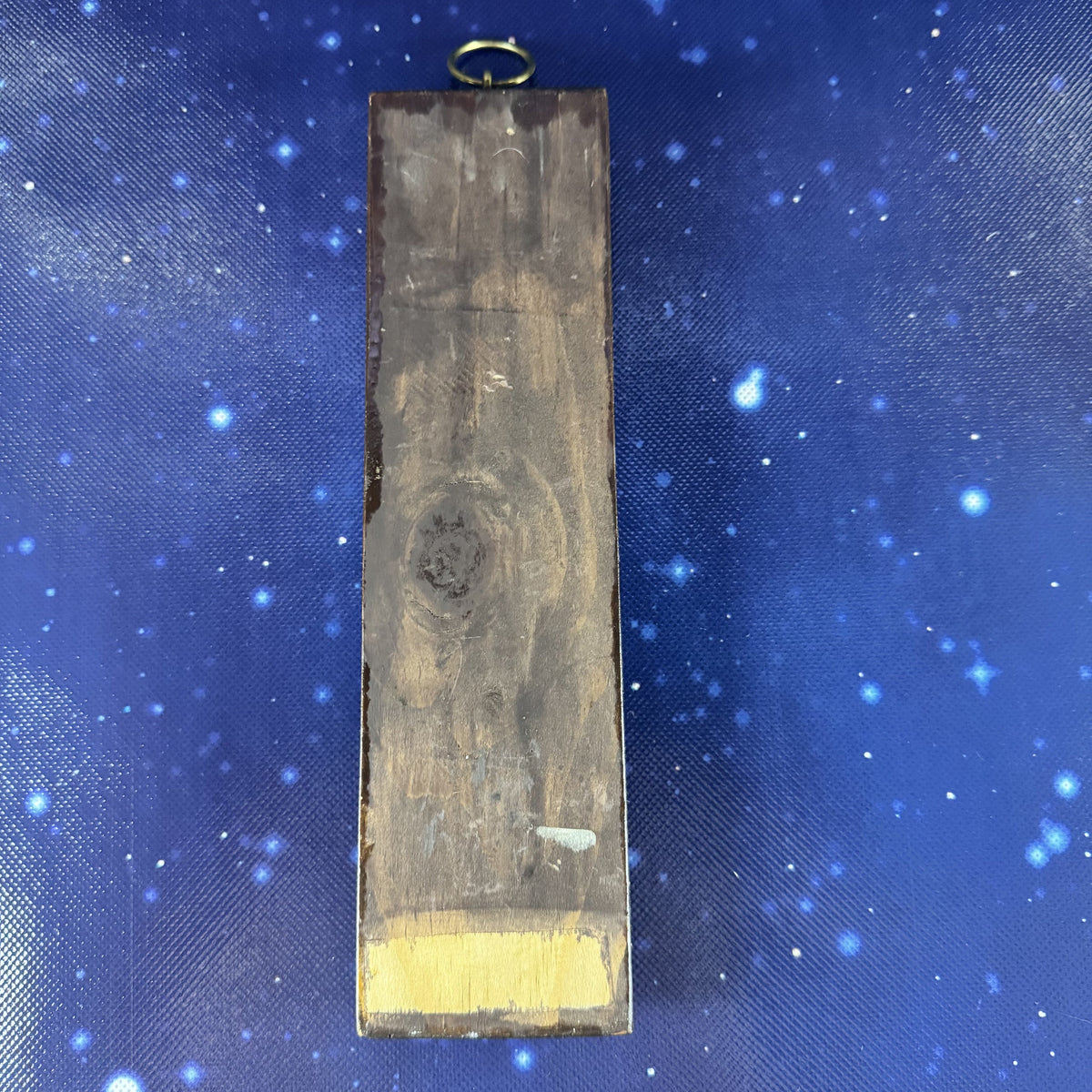 Wooden block with gold leaf on a blue fabric background