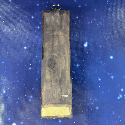 Wooden block with gold leaf on a blue fabric background
