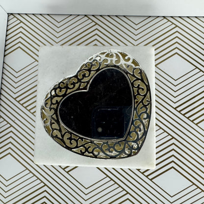 Silver-toned, heartshaped jewelry box with faux pearl clasp. Velvet-lined interior.