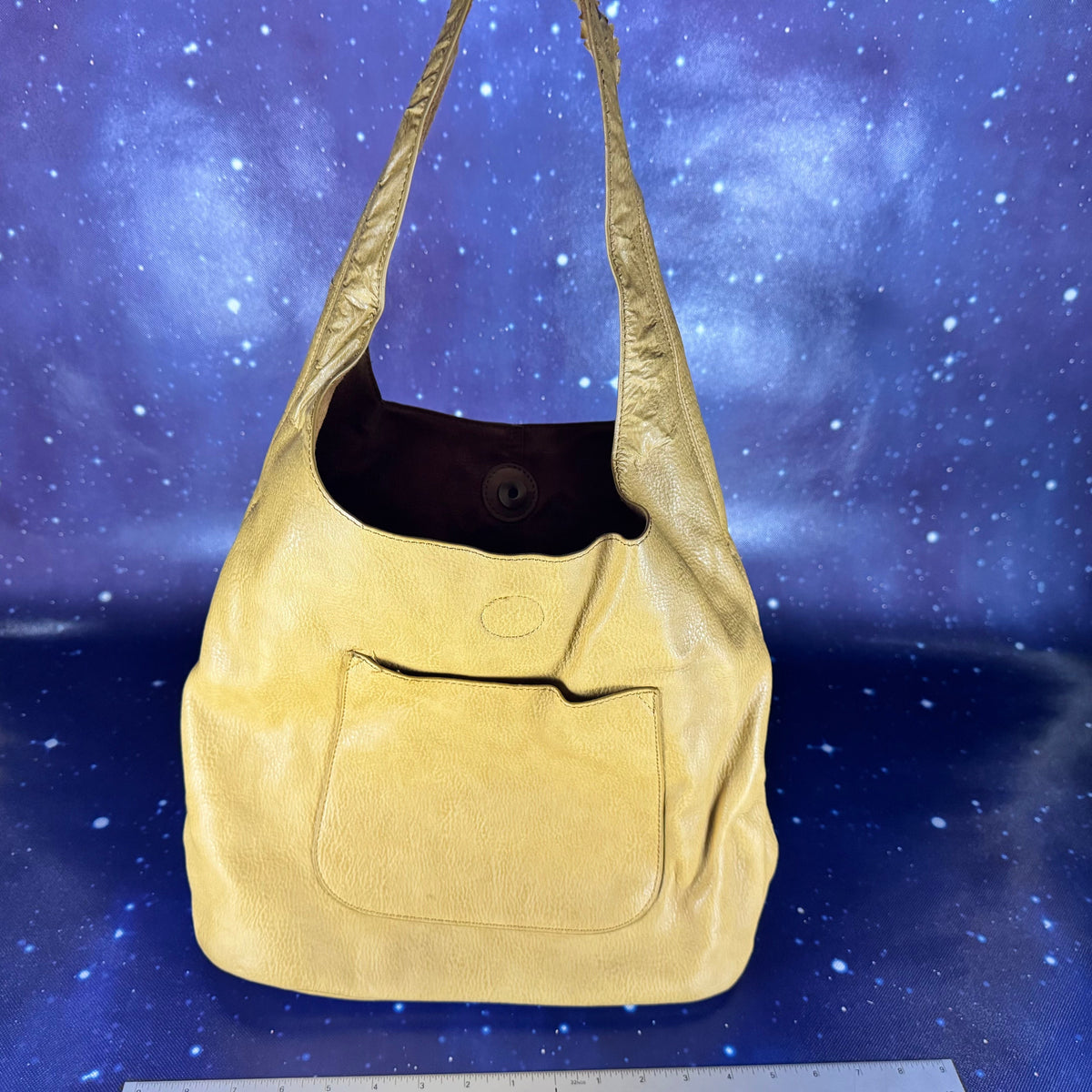 Beige shoulder bag on a starry night sky background