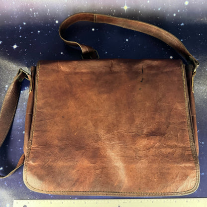 Brown leather bag on a starry night sky background