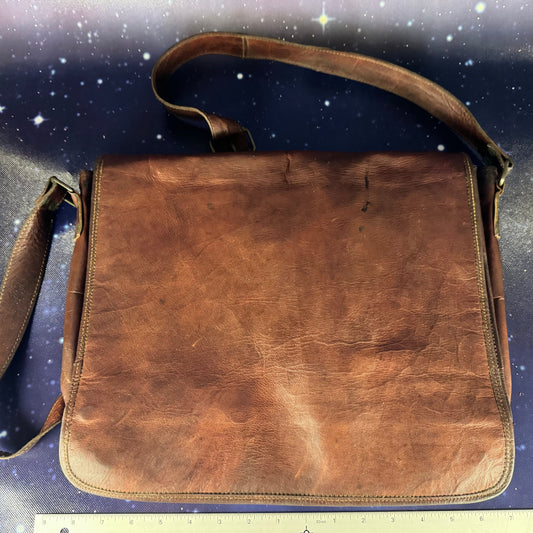 Brown leather bag on a starry night sky background