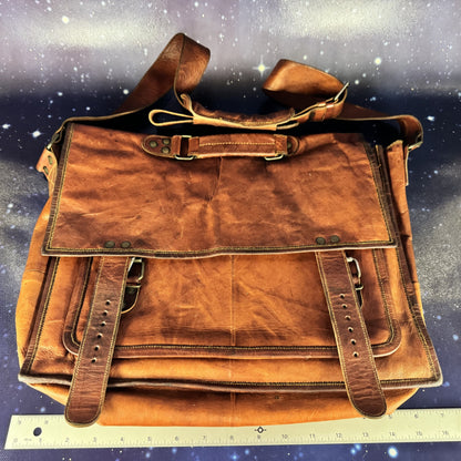 Brown leather bag on a starry night sky background with a ruler at the bottom.