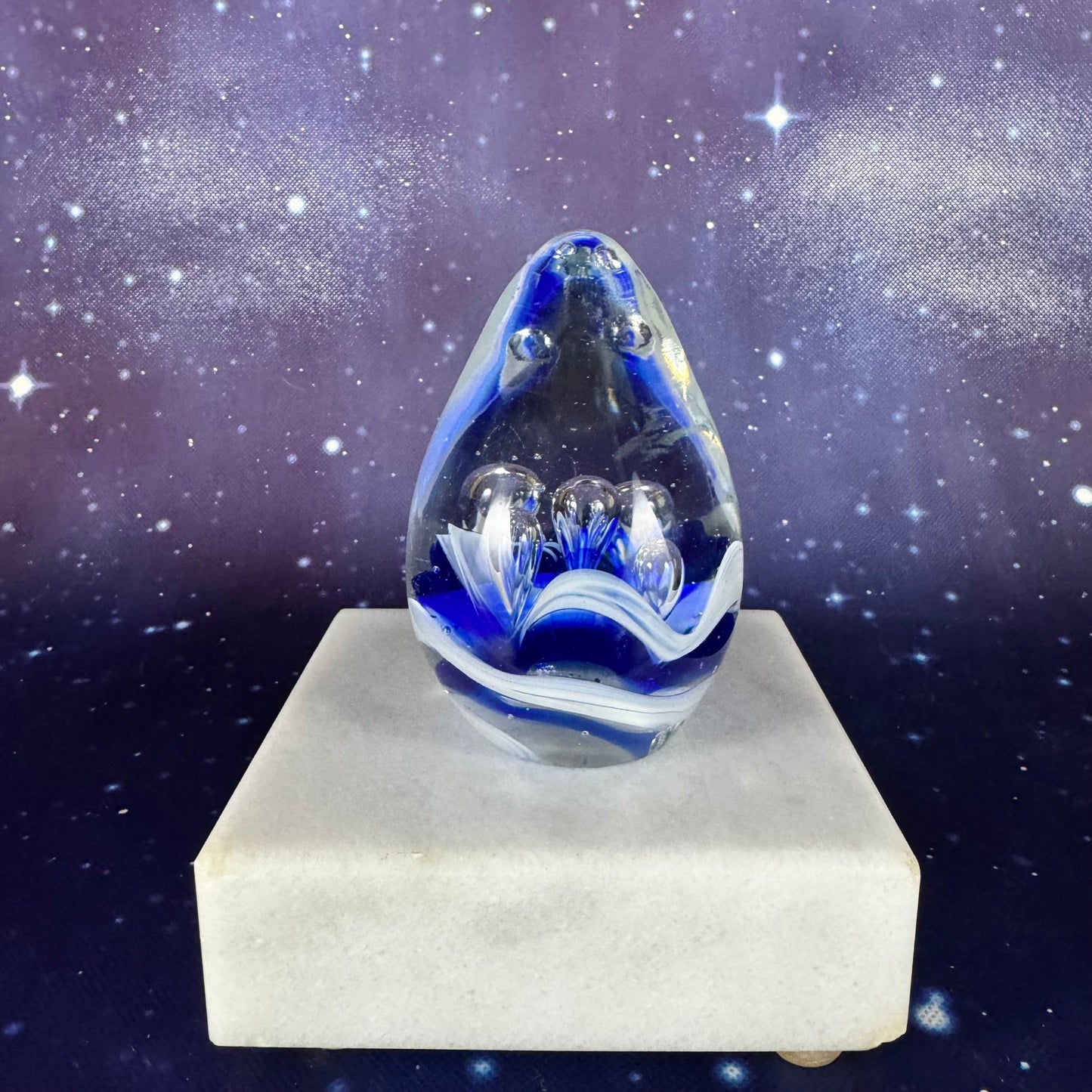 Egg-shaped Glass Paperweight with Blue Splash Design
