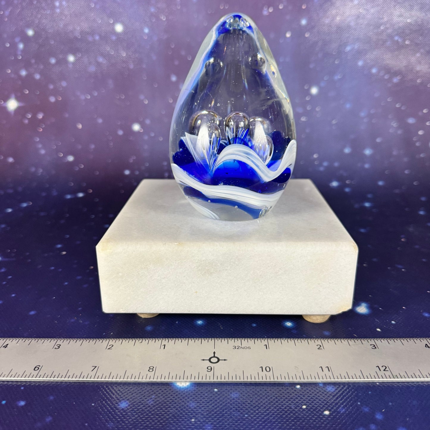 Egg-shaped Glass Paperweight with Blue Splash Design